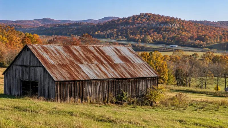 Older barn with a rusted metal roof in rural Hardin County